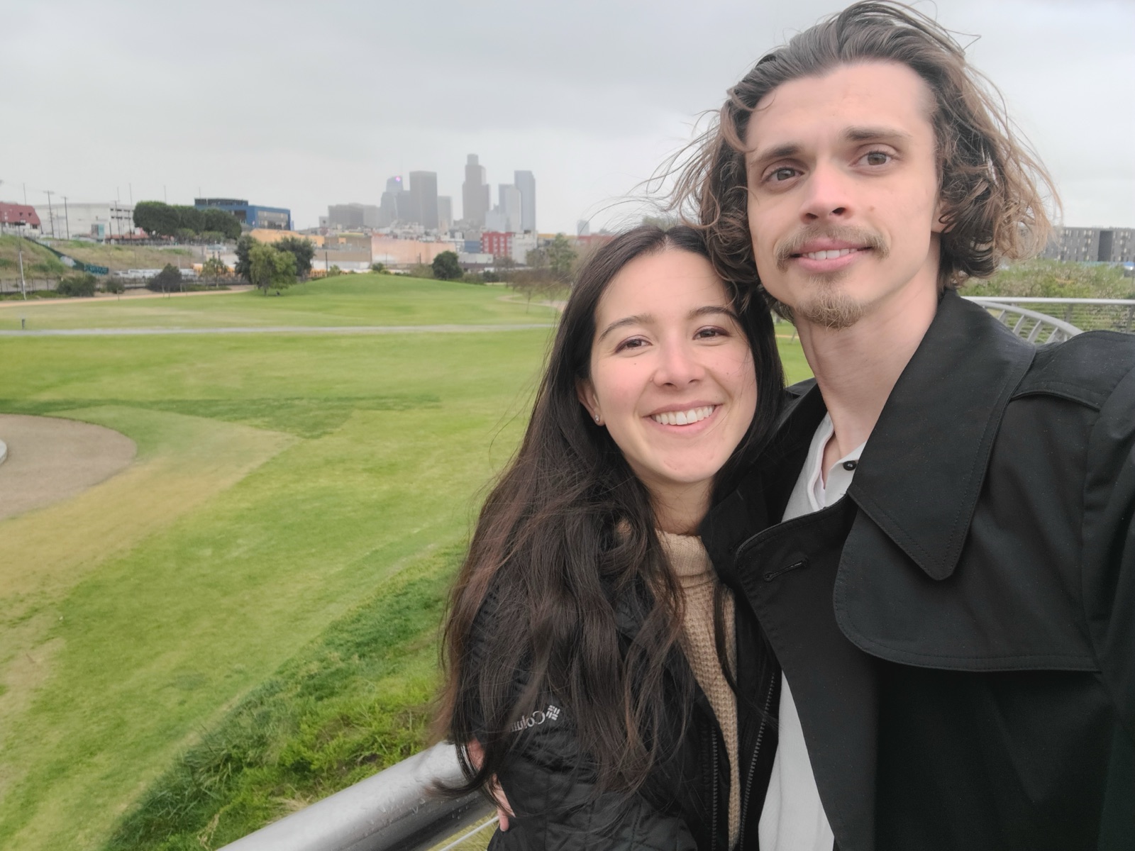 Cece and Logan at the bridge with the LA skyline