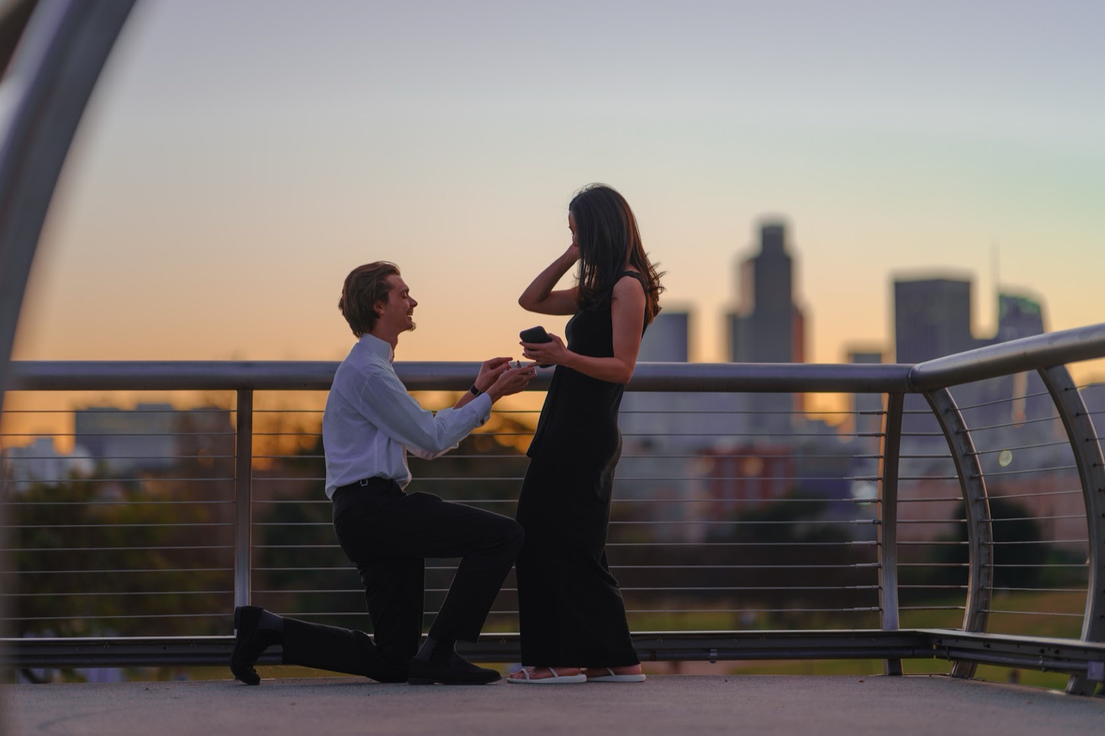 Logan proposing to Cece at sunset over the LA skyline