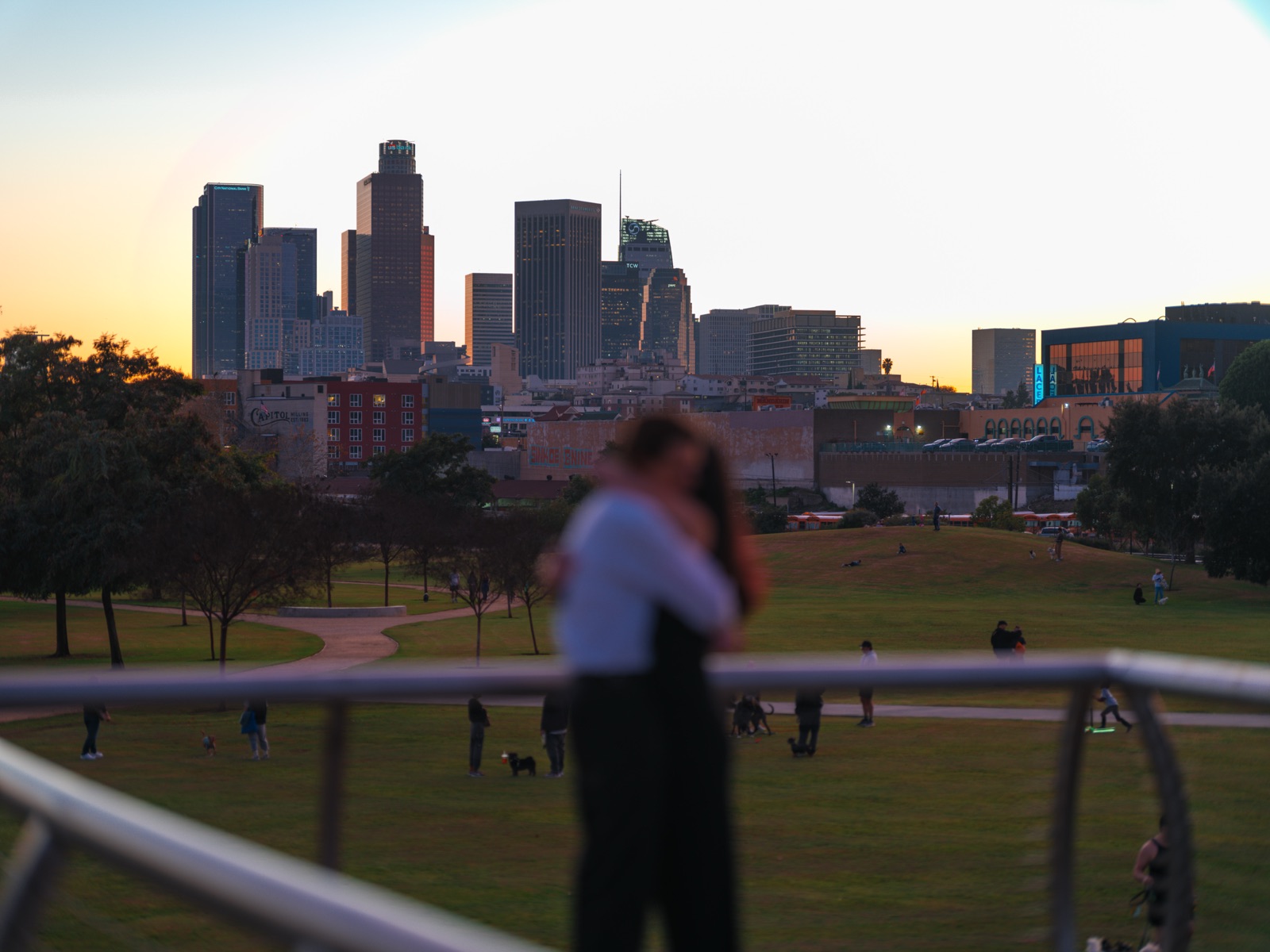 The couple embracing at golden hour over Downtown LA