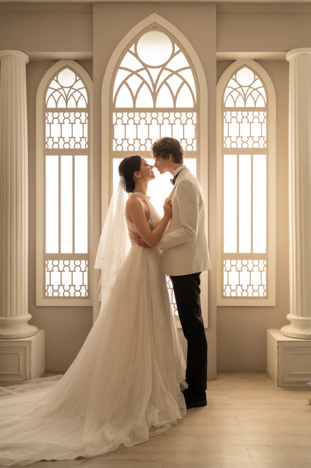 Cece and Logan in wedding attire, nearly kissing in an elegant chapel